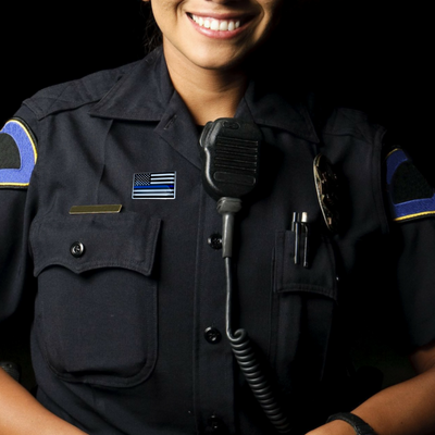 female officer smiling and wearing a police lapel pin