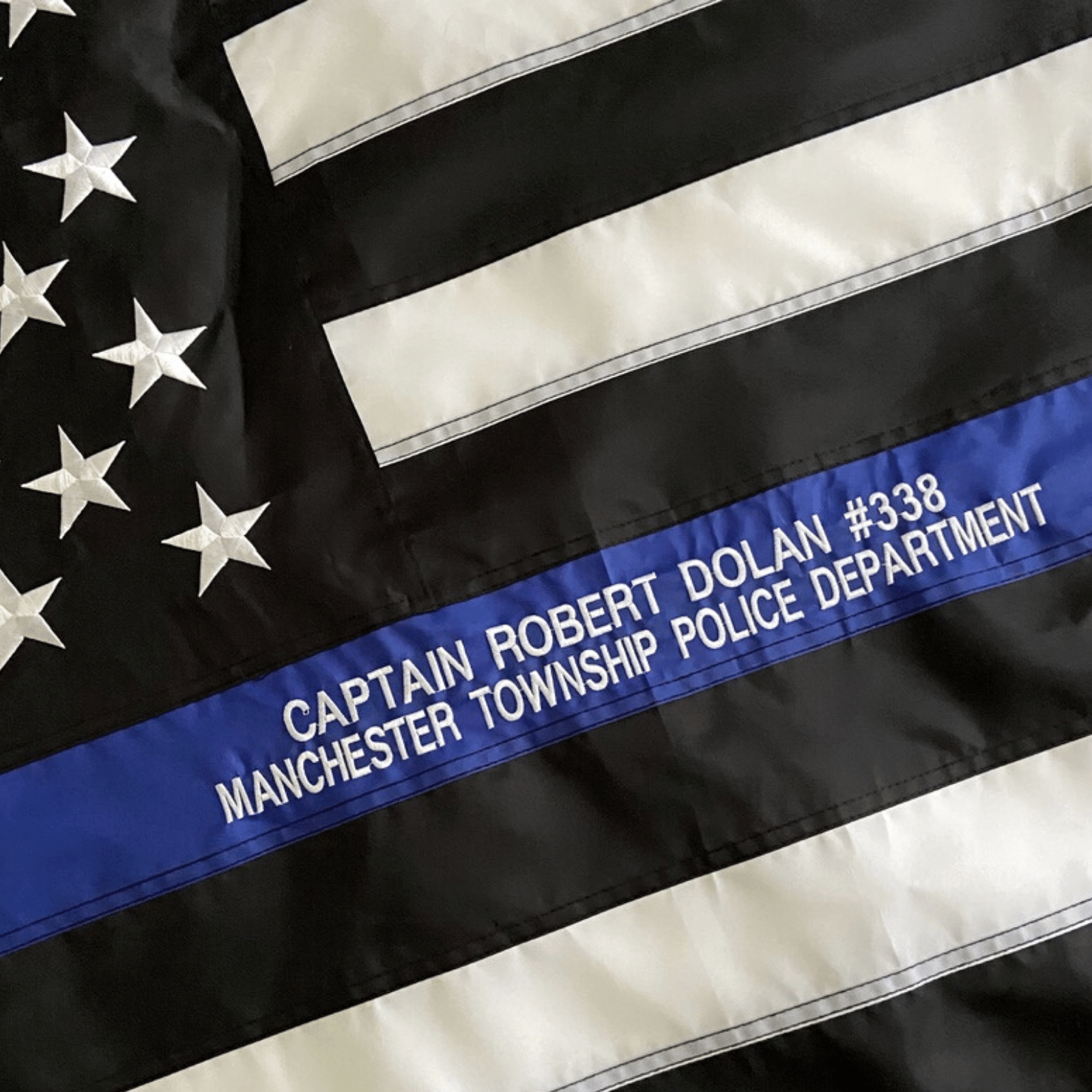 Custom Embroidery on Thin Blue Line Police Flag Officer Name and Badge