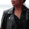 woman wearing leather jacket win thin blue line flag on lapel